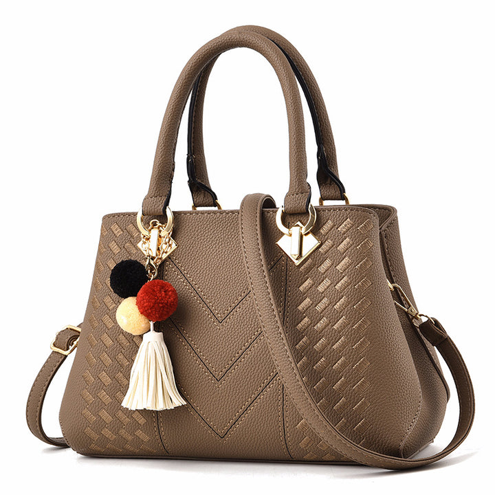 Embossed top handle handbag with pompom