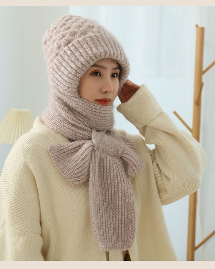Woman wearing a knitted hood with attached scarf