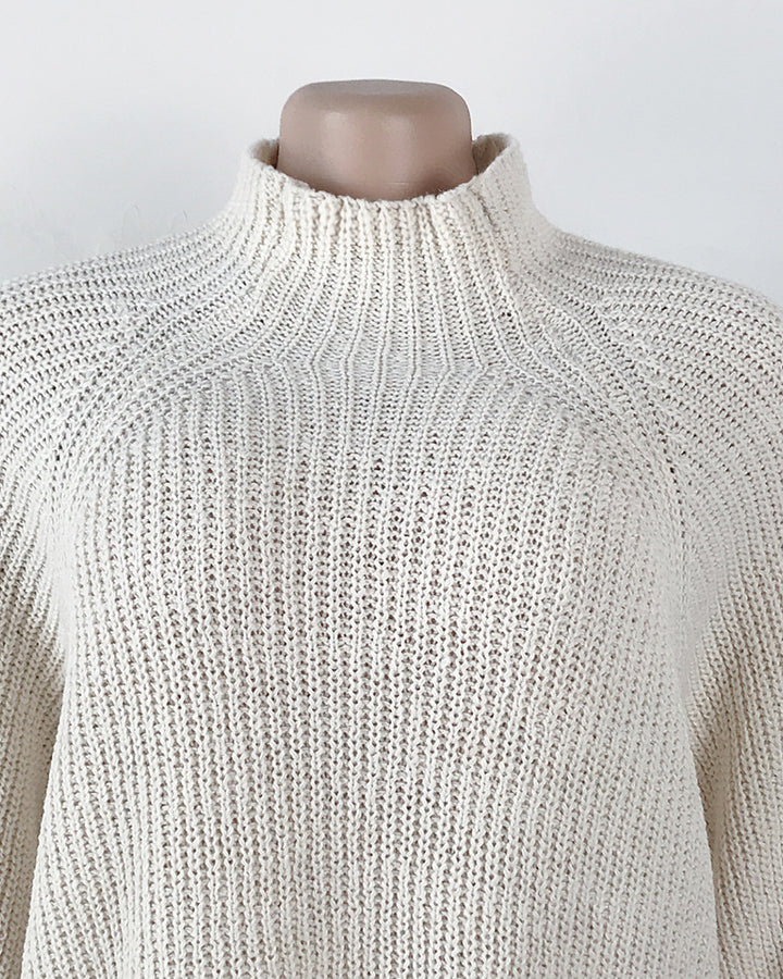Woman in oversized roll neck jumper dress