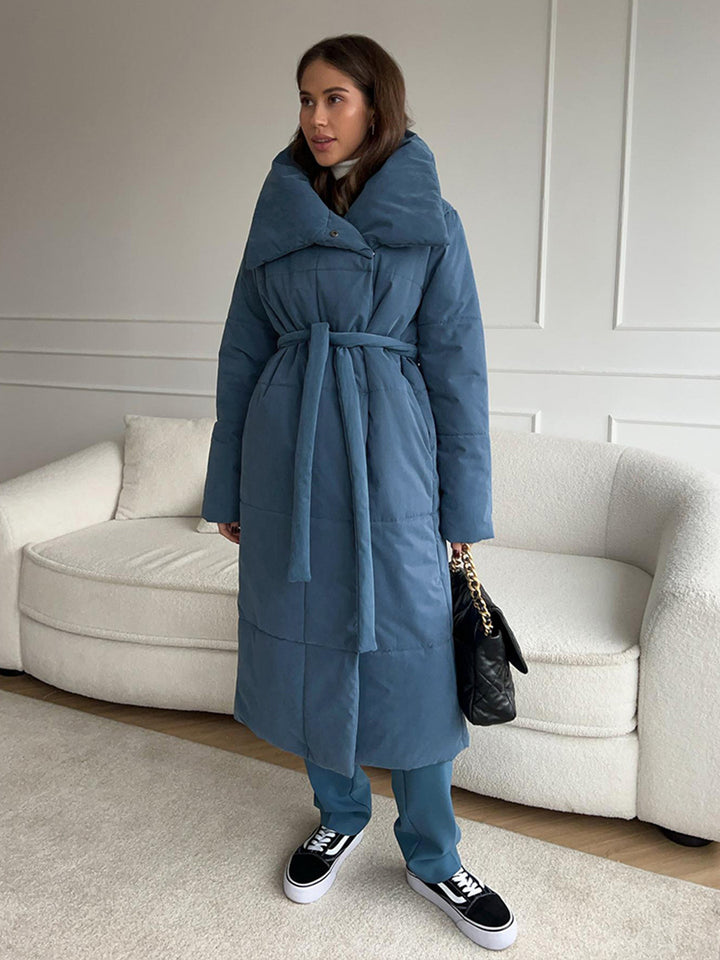 Woman in a long quilted coat with belt