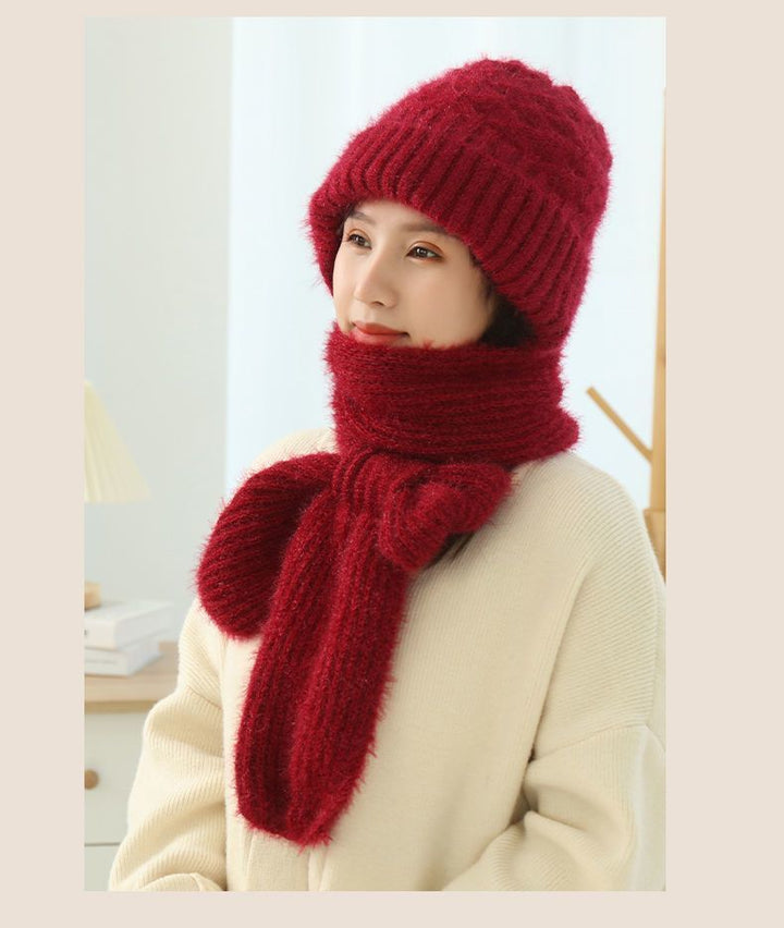 Woman wearing a knitted hood with attached scarf
