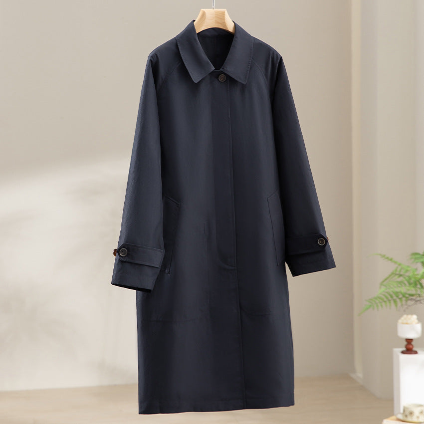 Women Longer minimalist trench coat with concealed button placket and adjustable cuffs