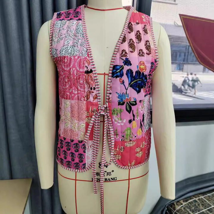 Ladies patchwork vest with tie belt, striped interior finish and contrast piping