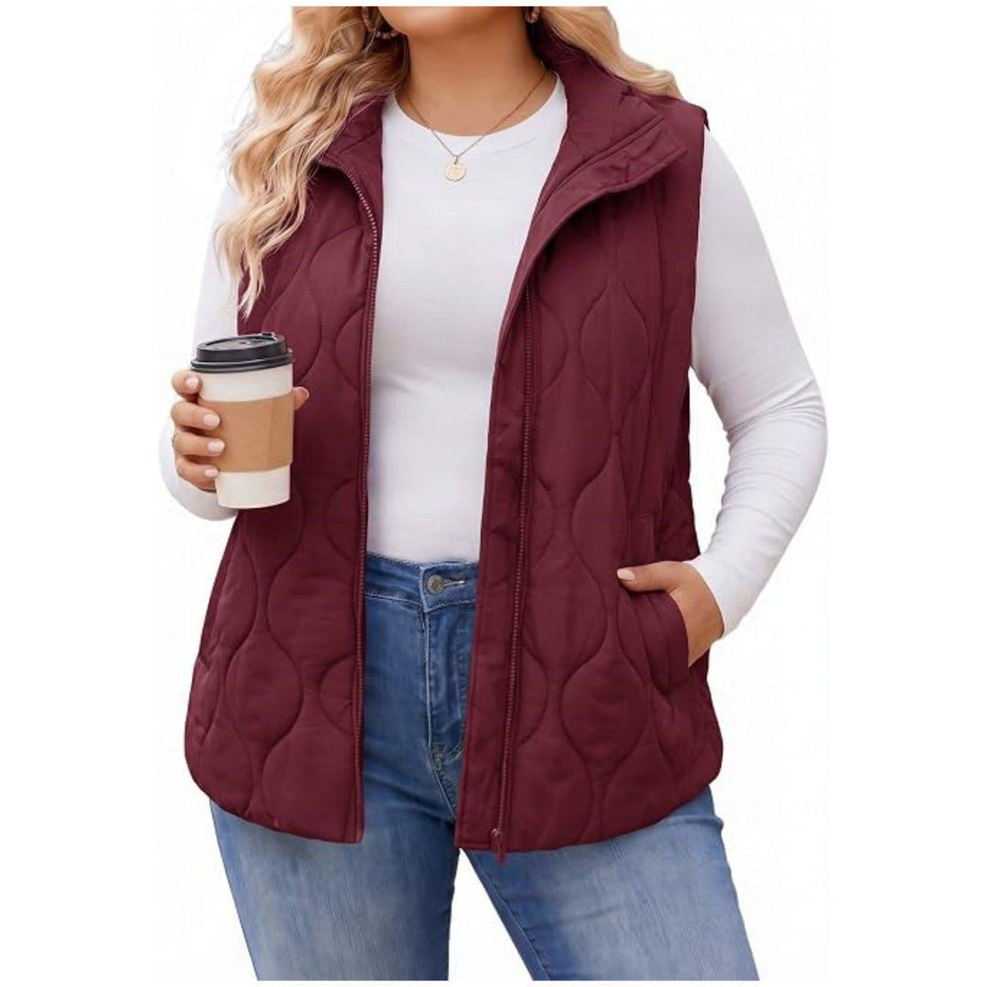 Ladies quilted vest with high collar, figure-flattering silhouette and side pockets