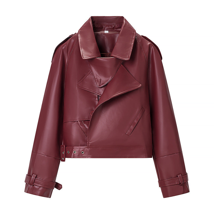 Women short cut biker jacket in leather look with asymmetrical lapel and waist belt