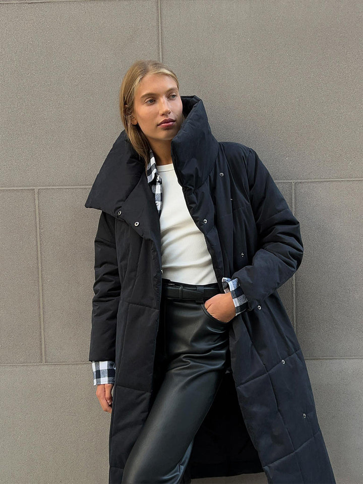 Woman in a long quilted coat with belt