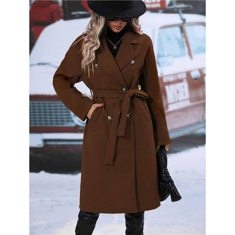 Woman in long belted double-breasted coat