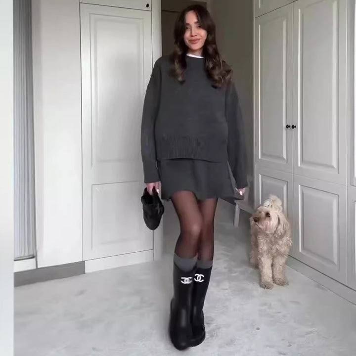 Woman in matching knitted jumper and mini skirt