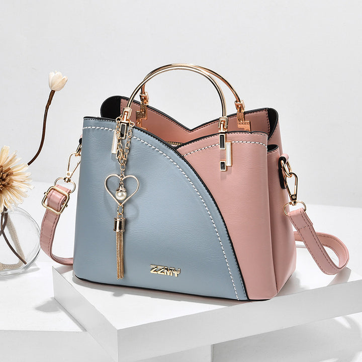 Colour block handbag with heart tassel